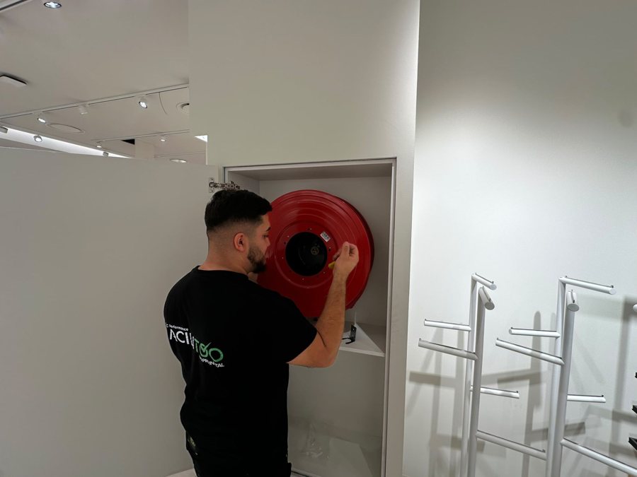 Facilitoo technician servicing a fire hose reel
